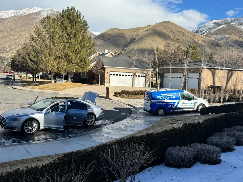 Cleaner Bros van next to a customer's car during a mobile detail at a home in Utah County