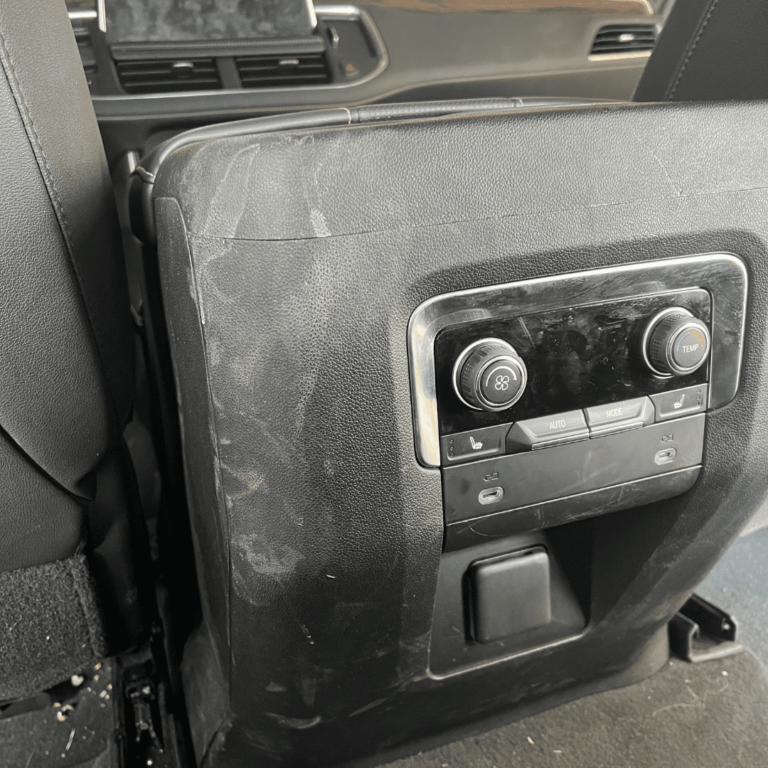Dirty center console before an interior detail