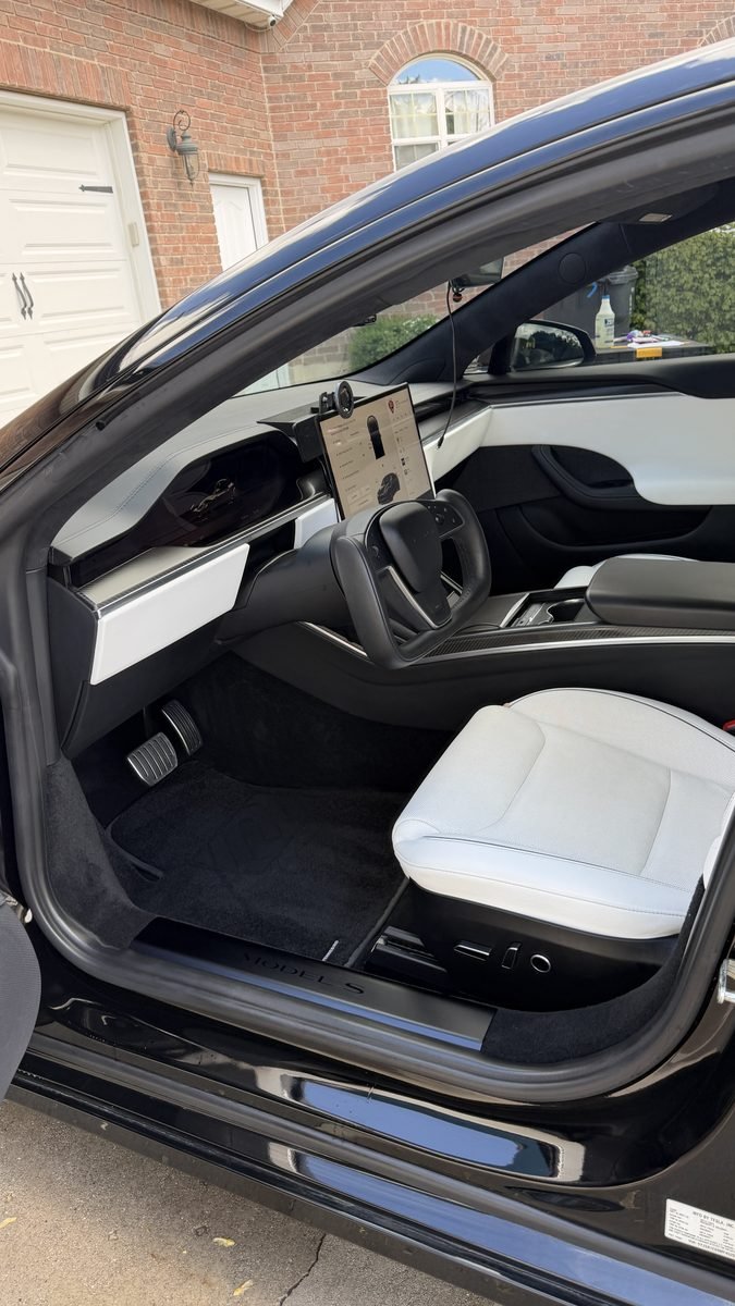 Clean white Tesla seats after an interior detail by Cleaner Bros