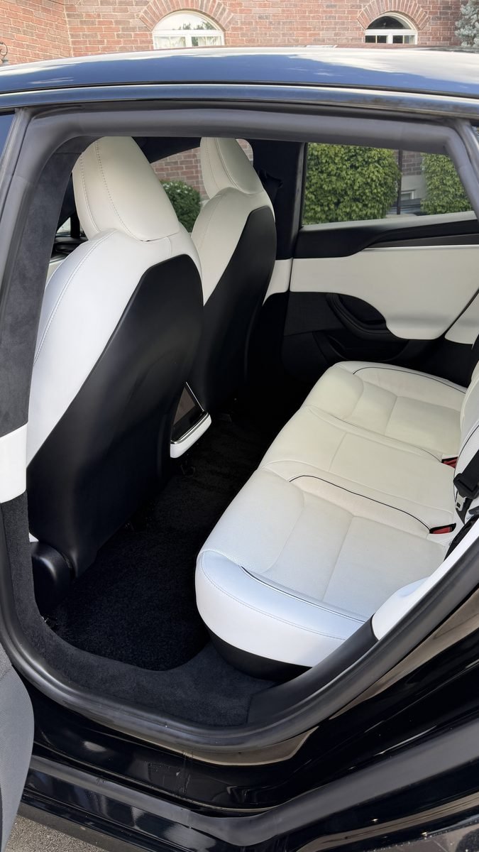 White Tesla rear seats after an interior detail in Highland