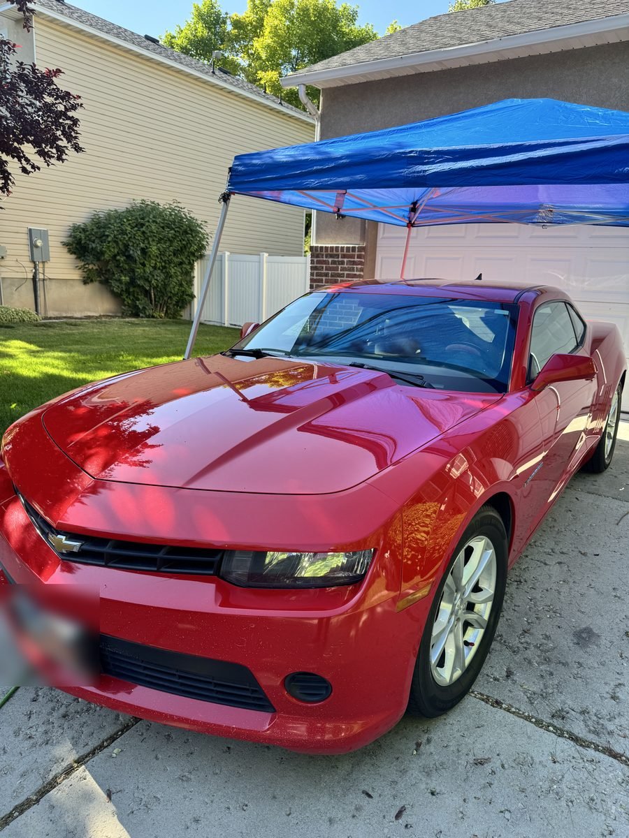 Red Camaro with glossy paint after polishing