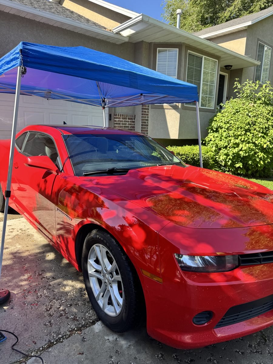 Red Camaro under our canopy during mobile scratch removal in Utah County